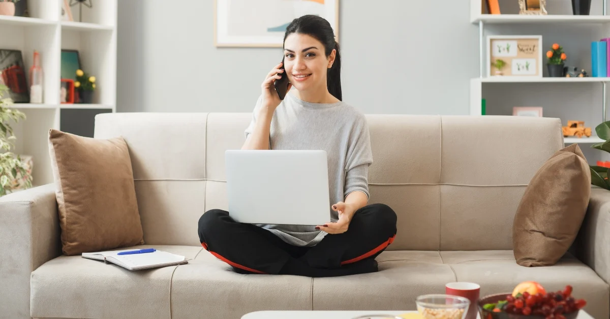 Image of a woman working on a laptop at home business setup.