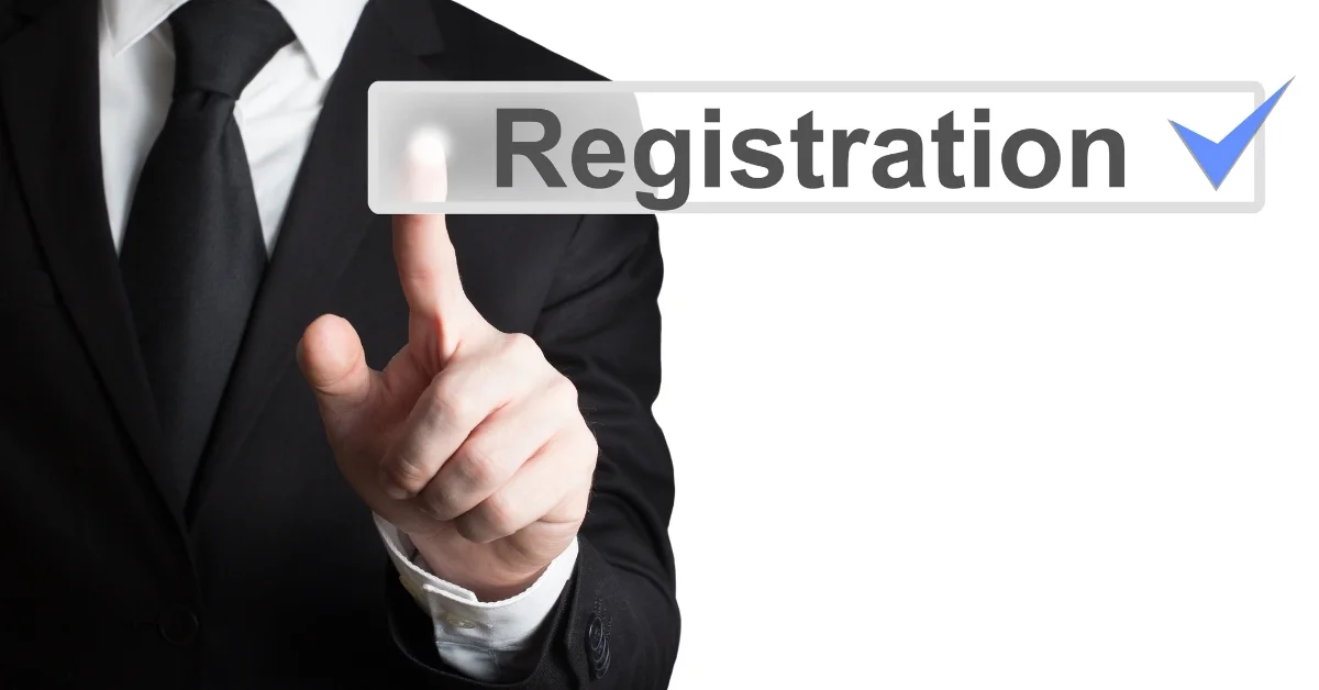 A person in a black suit with a black tie points at a button that says "Registration" with a blue checkmark on it. The background is white.