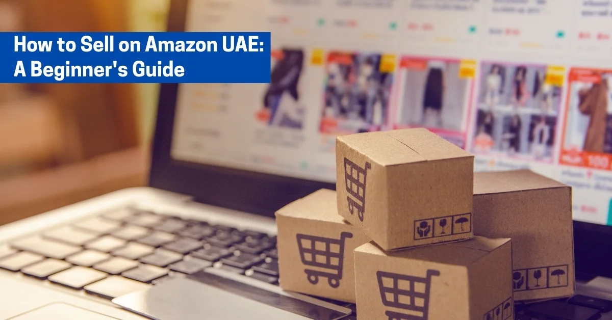 Image of small cardboard boxes with shopping cart icons placed on a laptop keyboard showing an e-commerce website, representing how to sell on Amazon UAE.