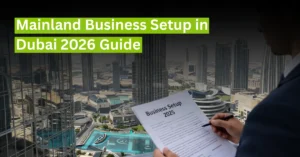 Dubai skyline with business professional reviewing documents and headline about Mainland Business Setup in Dubai 2026 Guide.