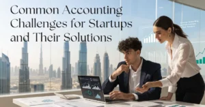Accounting Challenges Filing – Startup founder reviewing financial reports with a professional accountant in a modern UAE office while solving accounting challenges through accurate bookkeeping and financial management.