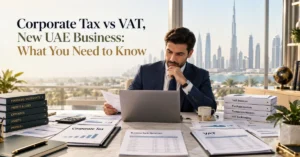 Corporate Tax vs VAT for a new UAE business showing financial statements, tax invoices and accounting records used for separate tax obligations.